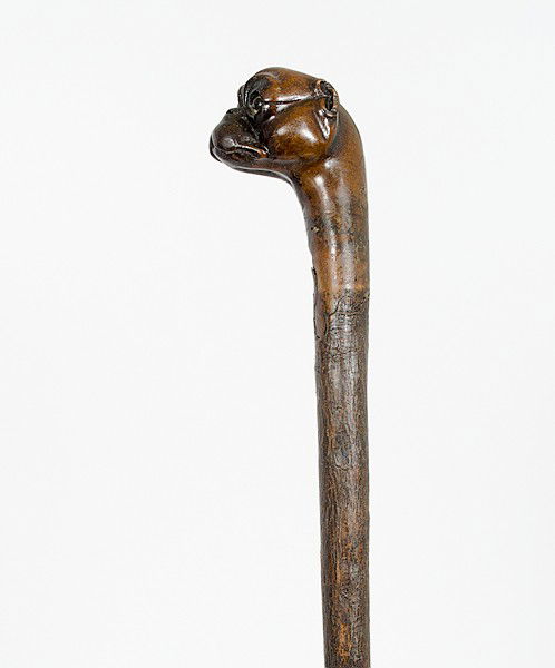 Folk Art Dog Head Cane : Folk Art Dog Head Cane American, early 20th century, a carved dog head walking cane with glass eyes; lg. 35 in.