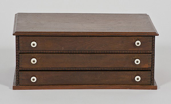 Oak Spool Cabinet : Oak Spool Cabinet American, 19th century. Aa three-drawer oak spool cabinet with porcelain knobs; 8.5, lg. 21, dp. 14 in.