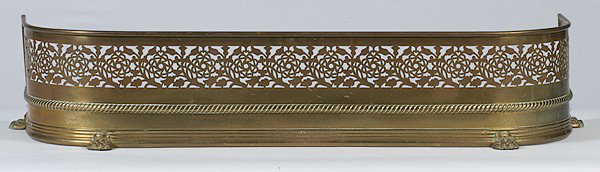 Brass Fender and Fire Place Tools : Brass Fender and Fire Place Tools American, 20th century. A brass fender having pierced decoration at top and applied claw feet, ht. 8.5, wd 41.5 in; plus, a set of three-piece brass fire-place tool