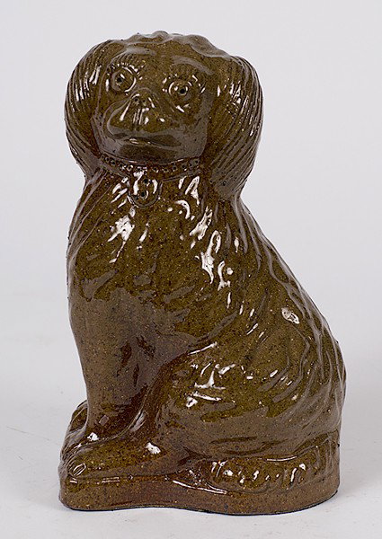 Ohio Spaniel Sewer Tile : Ohio Spaniel Sewer Tile American. A sewer tile seated spaniel, having a well-defined incised collar and tooled facial detail, in a mottled brown glaze, with incised initials E.S.; ht. 11 in.
