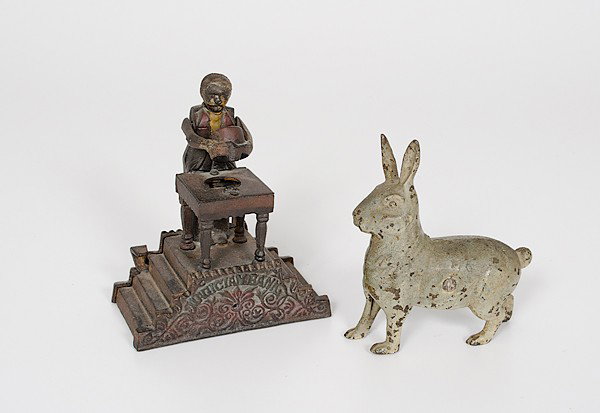Cast Iron Magician and Rabbit Bank : Cast Iron Magician and Rabbit Bank 19th century. A cast iron mechanical "Magician Bank," ht. 7.5, wd. 6.5 in.; plus, a cast iron standing rabbit bank with old paint; ht. 6.5 in.