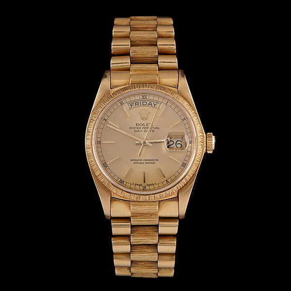 Gold Rolex Oyster Perpetual Watch : Gold Rolex Oyster Perpetual Watch A Rolex 18K yellow gold President wristwatch, sapphire crystal, fluted bezel with a champagne gold dial, gold bar markers, day and date apertures, gold batons; the