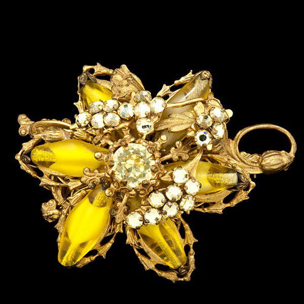 Miriam Haskell Mustard Color Rhinestone Brooch/Pen: Miriam Haskell Mustard Color Rhinestone Brooch/Pendant A Miriam Haskell flower motif Brooch/Pendant. A mix of oblong mustard color beads and rhinestones arraigned in a floral design with signature.