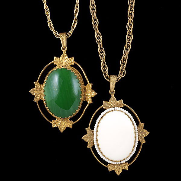 Miriam Haskell Suite : Miriam Haskell Suite Signed Miriam Haskell necklaces; both have a large pendant with leaf accents, opaque green and white respectively on an 18in. chain. Metal is gold in color.