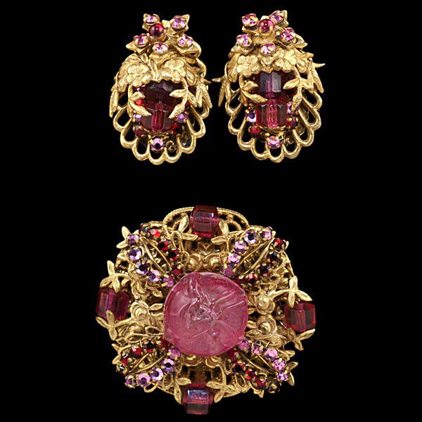 Miriam Haskell Magenta Collection : Miriam Haskell Magenta Collection A Miriam Haskell brooch and earring suite. The brooch is a mix of frosted magenta toned beads and rhinestones on a gilt flower setting with a large carved center be