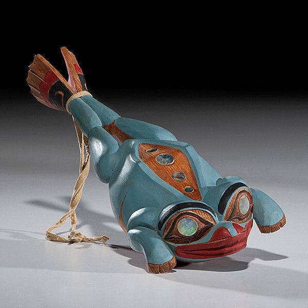 Don Lelooska Kwakiutl Carved Frog Rattle : Don Lelooska Kwakiutl Carved Frog Rattle Carved of cedar and painted in blue, black, and red; man's face carved on belly of frog; abalone eyes and spots on back; unsigned, length 12 in. third quarte