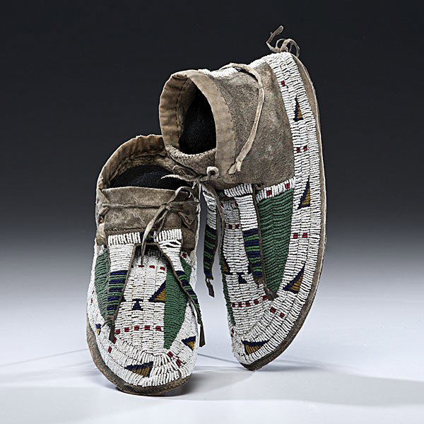 Sioux Beaded Hide Moccasins : Sioux Beaded Hide Moccasins Thread and sinew-sewn using bead colors of pea green, white, dark blue, red white-heart, and amber; forked tongues terminate with flattened tin cones; cuffs lightly decor