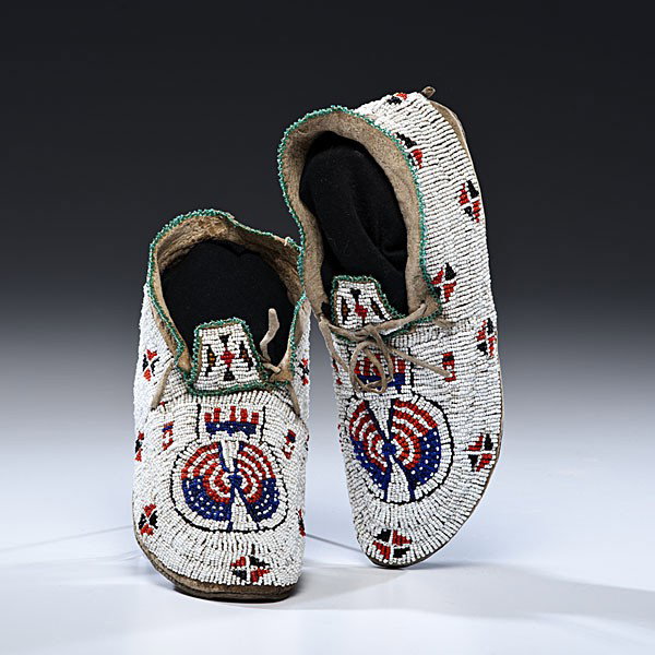 Sioux Beaded Hide Moccasins : Sioux Beaded Hide Moccasins Thread-sewn and beaded using red, black, white, and blue; with US shield and banners on vamps, length 10 in. second quarter 20th century