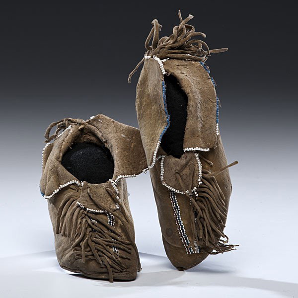 Kiowa Child's Beaded Hide Moccasins : Kiowa Child's Beaded Hide Moccasins Thread and sinew-sewn and beaded using colors of white, pony trader blue, and rose; dusters trail heel seam and short fringe decorate vamps, length 6.5 in. fourth