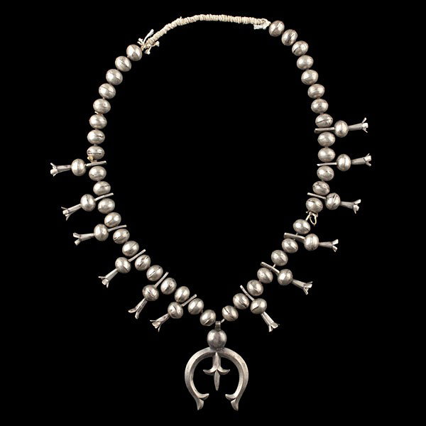 Navajo Squash Blossom Collected by Virginia Donegh: Navajo Squash Blossom Collected by Virginia Doneghy (1900-1981) Single strand of large handwrought silver beads; 12 blossoms, each with a four prongs and a pierced extension for stringing; each exte