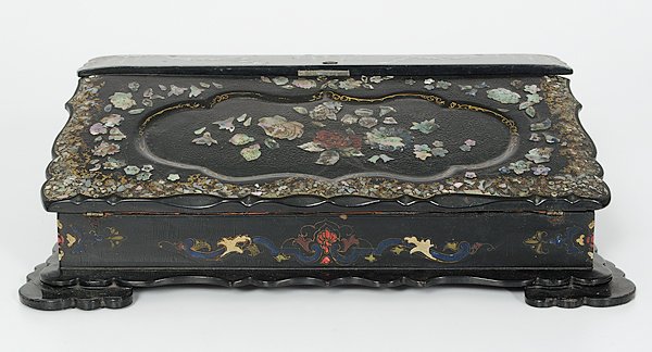 English Papier Maché Lap Desk : England, ca 1850s. A papier maché lap desk with scalloped edges, inlaid mother-of-pearl, and hand-painted. The interior with fitted compartments and baize writing surface;