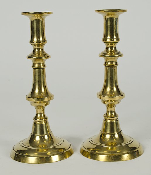 English Brass Candlesticks : England, 19th century. A pair of brass candlesticks with round bases; ht. 9 in.
