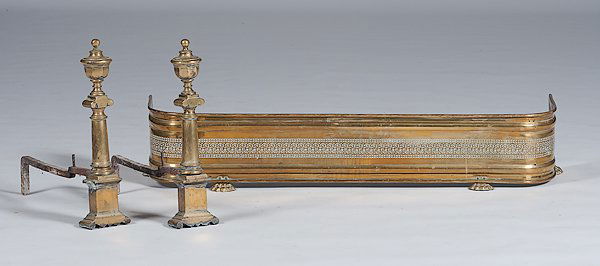 English Fender and Andirons : England. A brass footed fender with a open-work band; ht. 9, lg. 48 in. Plus a pair of Victorian bronze andirons; ht. 21 in.