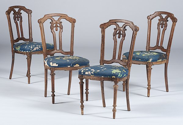 French Louis XVI-style Chairs : France, early 20th century. Four Louis XVI-style side chairs in walnut with a carved crest rail, pierced and carved splat, and rising on tapering legs with thimble feet; ht. 34.5 in.