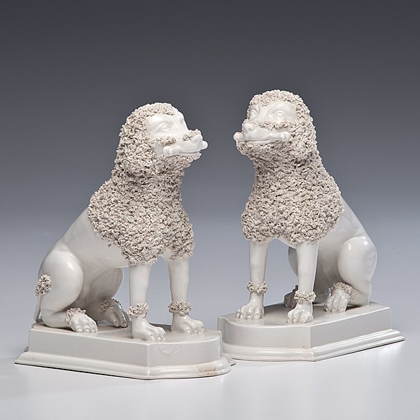 House of Dior Ceramic Dogs : France, ca 1946. A pair of Christian Dior creamware ceramic seated poodles on a plinth base, marked Christian Dior; ht. 8.75 in. Backed by Marcel Boussac, Christian Dior the House of Dior on 16 Decemb