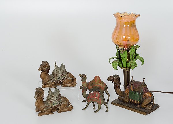Cold Painted Metal Camels : 20th century. Five cold painted metal camels, including a pair of seated camels with saddles, a lamp rising out of a palm tree with a seated camel at its base, and two standing camels; lamp ht. 13 in.