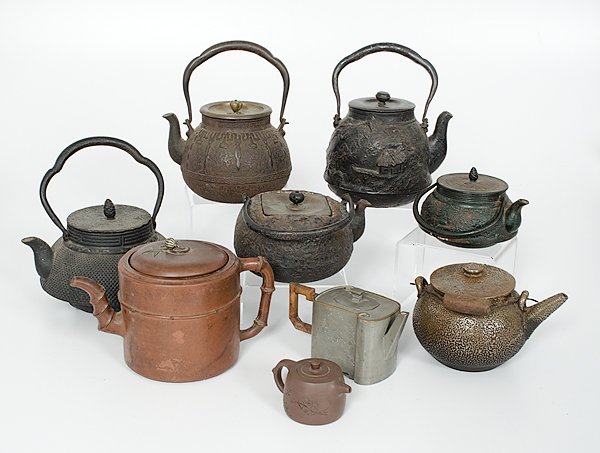 A Collection of Chinese and JapaneseTeapots : China and Japan, 19th-20th c. Includes five bronze teapots, one yixing ceramic teapot with a wax export seal, one pewter pot with Japanese marks on the bottom, one copper teapot with enameled overglaz