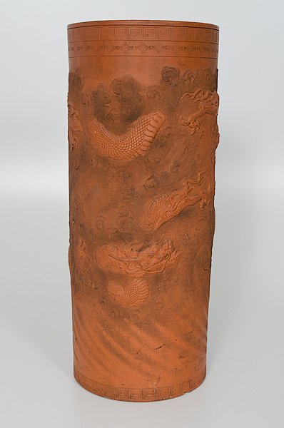 Tokoname Ware Umbrella Stand : Japan, 19th century. A Tokoname terra cotta umbrella stand having three-clawed dragons amid swirling clouds in relief; the base with three character mark; ht. 24.5 in.