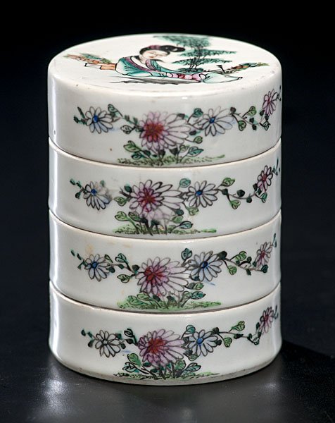 Chinese Porcelain Stack Pot : China. A porcelain stack pot with four trays and having characters among floral painted motifs; ht. 4 in.