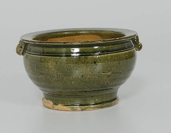 Chinese Earthenware Bowl : China. An earthenware bowl having two small handles and covered in a green glaze, unmarked; dia. 6.5 in.