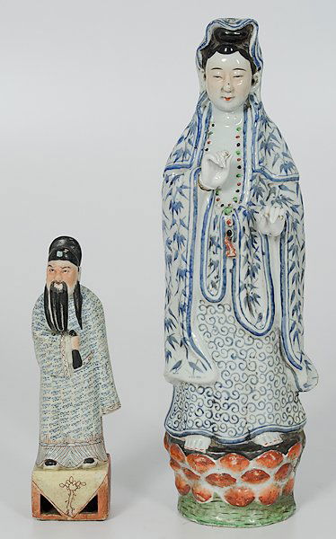 Chinese Porcelain Figures : China. Two porcelain figures including a female figure standing on a lotus flower, wearing flowing robes tied in a dhoti at the waist, unmarked, and a male figure standing on a rectangular base wearin