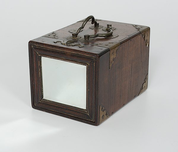 Chinese Dressing Box with Mirrors and Accessories : China. A dressing box with a slide-out mirror revealing a rectangular fold-up mirror and two dovetailed drawers with riveted metal handles, the drawers contain an additional mirror, two brushes, four 