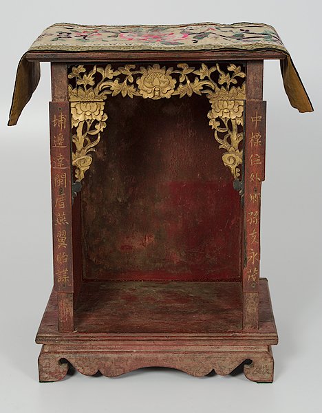 Chinese Wooden Buddhist Altar, Plus : China. A painted red wooden Buddhist altar, with calligraphic Chinese script along the front pillars, having carved and gilded floral decoration along the top edge. PLUS, a Chinese embroidered tapestr