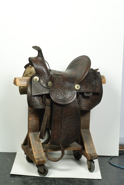 U.S. Western Stock Saddle by F.A. Meanea maker Che: U.S. Western Stock Saddle by F.A. Meanea maker Cheyenne, WY. Ca 1890-1920. Entire saddle including the leather stirrups are heavily tooled with floral and vine patterns. Eight German steel bosses, t