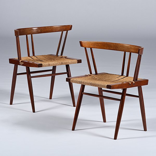 George Nakashima Chairs: George Nakashima Chairs American, 20th century. A set of two modernist George Nakashima (1905-1990) walnut grass-seated chairs. Each chair having a curved back rail over spindles, with a natural cord 