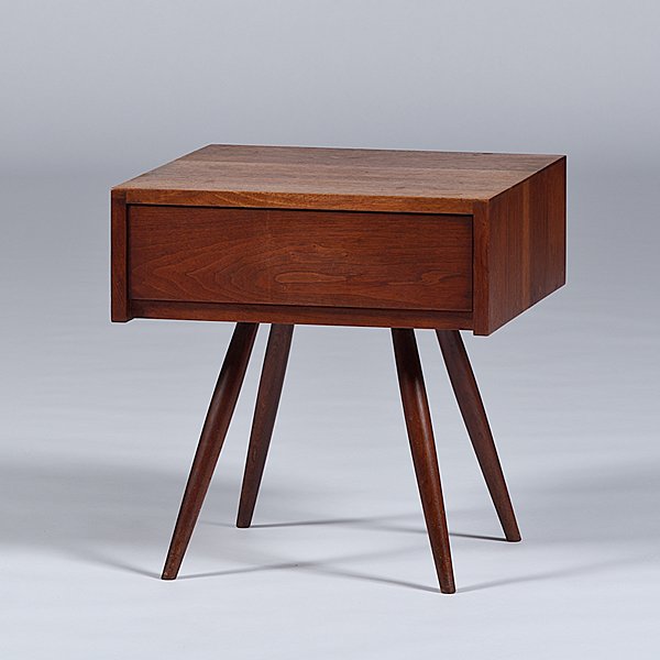 George Nakashima Nightstand: George Nakashima Nightstand American, 20th century. A modernist George Nakashima (1905-1990) walnut nightstand, with one drawer on flaring dowel legs; ht. 21, wd. 20, dp. 20 in. Provenance: Purchased 