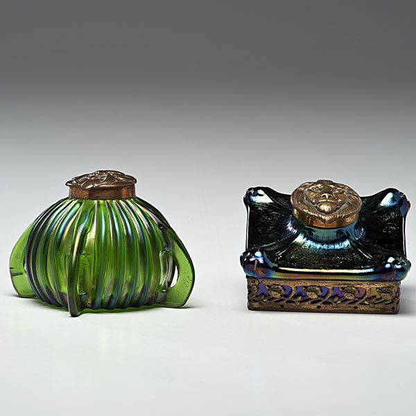 Loetz Inkwells: Loetz Inkwells Austrian. Two art glass inkwells in the style of Loetz, including one spherical green inkwell, and one green iridescent square-shaped inkwell, both with brass lion's mask lids, both unm