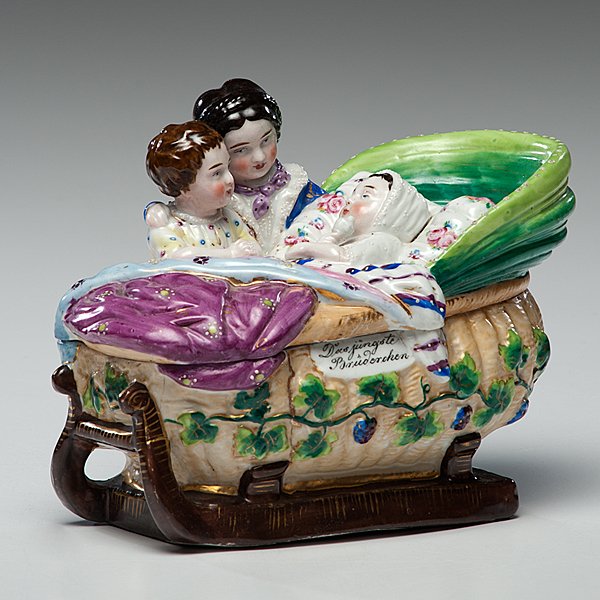 German Figural Inkwell: German Figural Inkwell Probably German or Bavarian. A figural porcelain inkwell with baby in a bassinet surrounded by two children, with the inscription Das jÃ¼ngste BrÃ¼derchen (translated, the y