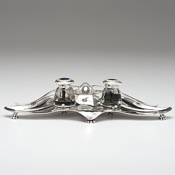 Edwardian Sterling Inkwell: Edwardian Sterling Inkwell English, ca 1910. A sterling silver inkwell raised on four paw feet, the tops of each inkwell with inlaid purple glass starburst cabochons, a pen rest and marks for London, 