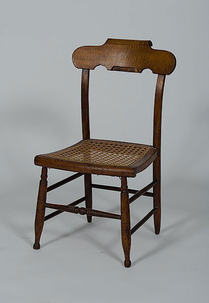 Child's Fancy Chair : Child's Fancy Chair American, a child's fancy chair in maple with a scrolled crest, caned seat, and rising on turned legs connected by stretchers; ht. 28 in.
