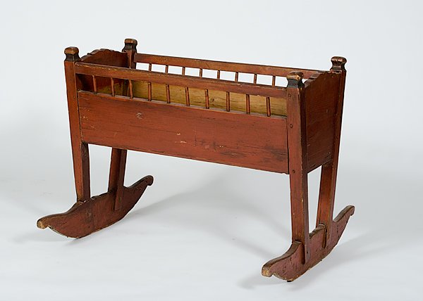 Painted Wood Cradle : Painted Wood Cradle American, early 20th century, a painted wood cradle with short spindle sides and scroll cut rockers; ht. 21. lg 37 in.