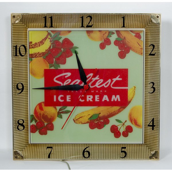 Sealtest Ice Cream Light-Up Electric Clock : Sealtest Ice Cream Light-Up Electric Clock A Sealtest ice cream light-up electric clock with molded plastic face and fruit motif, with metal case. 16 x 16 in.