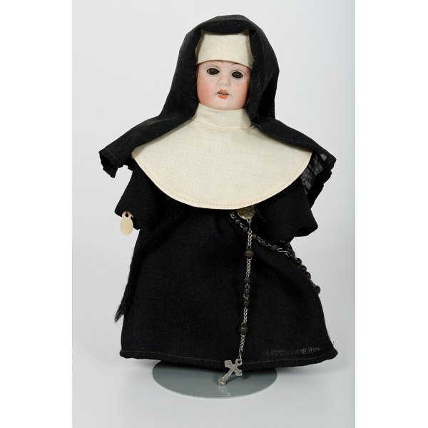 Kestner Bisque Nun Doll : Kestner Bisque Nun Doll Germany, early 20th century, a bisque head doll with brown glass eyes, open mouth with upper teeth, dressed in black woolen habit, linen collar and black beaded rosary to hip