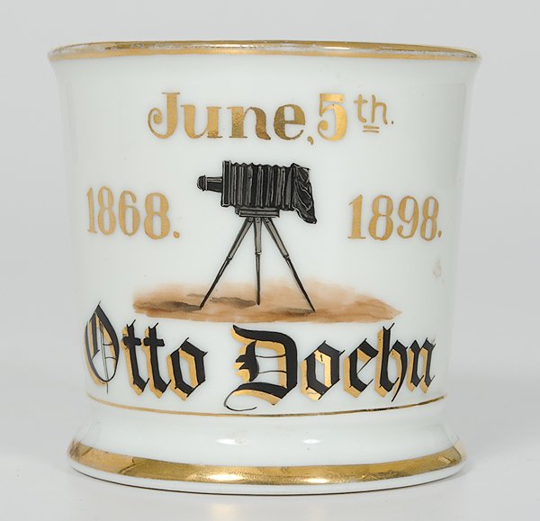 Photographer's Occupational Shaving Mug : Photographer's Occupational Shaving Mug Porcelain with polychrome painted scene of a camera. Gilt date reads June 5th 1868. 1898. Gilt name Otto Doehn. Marked Harold Bros, Barbers' Supplies, Clevela