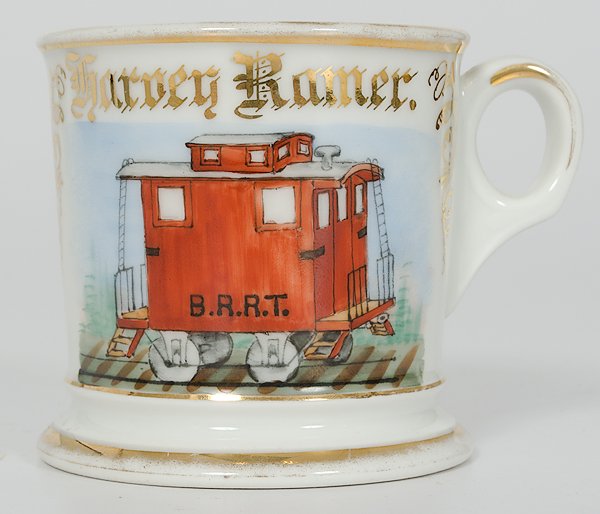 Occupational Shaving Mug with Caboose : Occupational Shaving Mug with Caboose Porcelain with polychrome painted caboose bearing the initials B.R.R.T. With gilt border and name Harvey Ramer. Underside marked in gilt Alpha. and stamped T&V 