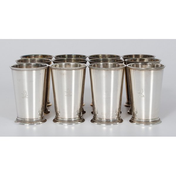 English Silver-Plated Beakers : English Silver-Plated Beakers English. A set of twelve silver-plated beakers, each with engraved creature (possible griffon) with spear through chest. All marked Made in England; ht. 5 in.
