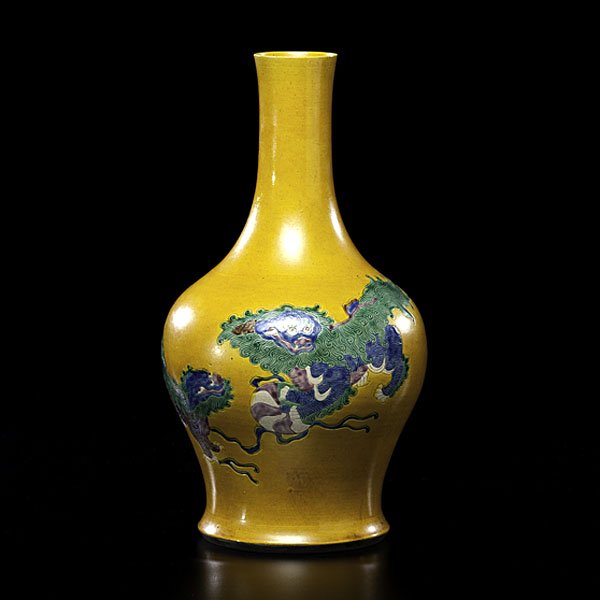 Chinese Sancai Dragon Vase : Chinese Sancai Dragon Vase Chinese, 19th century. A polychrome and porcelain bottle-form sancai vase, having two foo dogs chasing a fiery pearl on a mustard yellow ground, with a six-characte