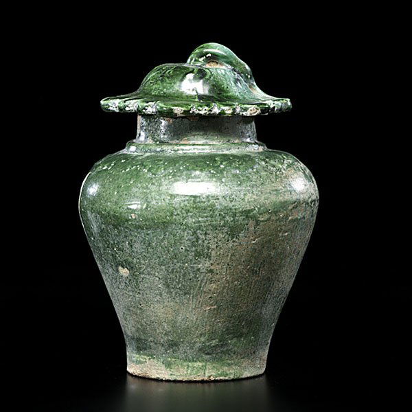 Chinese Ming Period Earthenware Jar : Chinese Ming Period Earthenware Jar Chinese, probably Ming period. An earthenware jar with molded decoration in the form of clouds and lotus plants under deep green glaze; 8 in. ht.