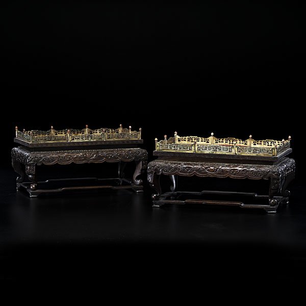 Chinese Rosewood and Ivory Stands : Chinese Rosewood and Ivory Stands Chinese, 18th century. A pair of jade stands in carved rosewood with foo dogs masks and archaic scrolling, the galleries of carved and stained ivory and bases