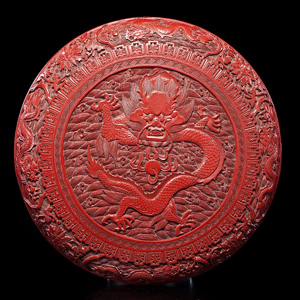Chinese Carved Cinnabar Box : Chinese Carved Cinnabar Box Chinese, 19th century. A carved cinnabar lacquer nine dragon round covered box, the top carved with a large full-faced five-claw dragon with a flaming pearl on a ground