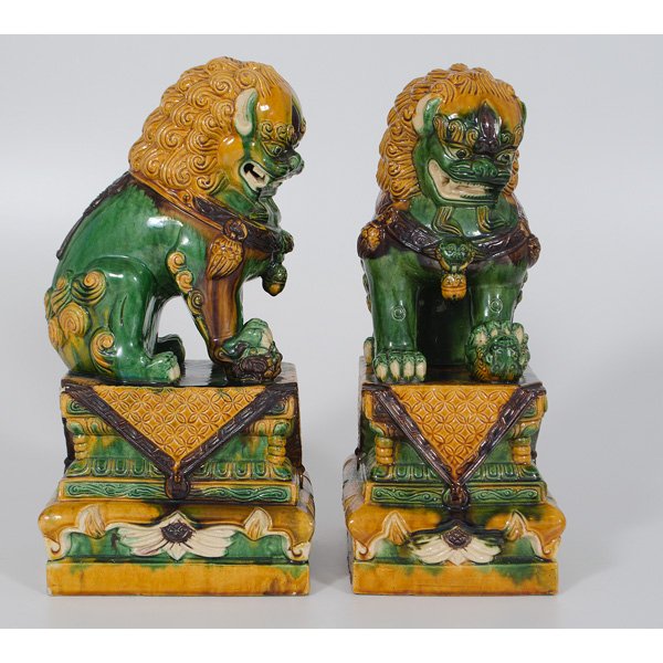 Chinese Sancai Foo Dogs : Chinese Sancai Foo Dogs Chinese. A pair of sancai foo dogs in mustard yellow, green and purple, each foo dog resting on a decorative plinth, unmarked; ht. 17 in.
