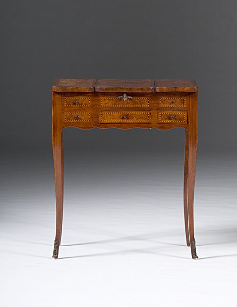 Louis XV-style Dressing Table : French, 19th century. A veneered and inlaid Louis XV-style dressing table in fruitwood, the top with hinged center having inlaid floral trophy, the ends opening outward to disclose wells, above a case