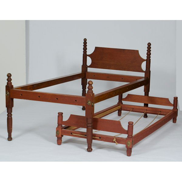 Four Poster Rope Bed in Red Stain with Trundle : American, 19th century. A pine four-poster rope bed with trundle in red stain having turned posts with acorn finials, shaped headboard; ht. 41.5, wd. 40.5, lg. (rails) 75 in.