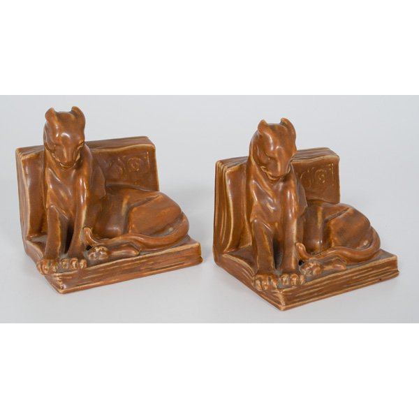 Rookwood Panther Bookends : American, a pair of Rookwood "Panther" bookends, covered in an orange-brown glaze, marked with the Rookwood flame logo, shape No. 2564, dated 1935; ht. 5.5, lg. 5.25, wd. 4 in.