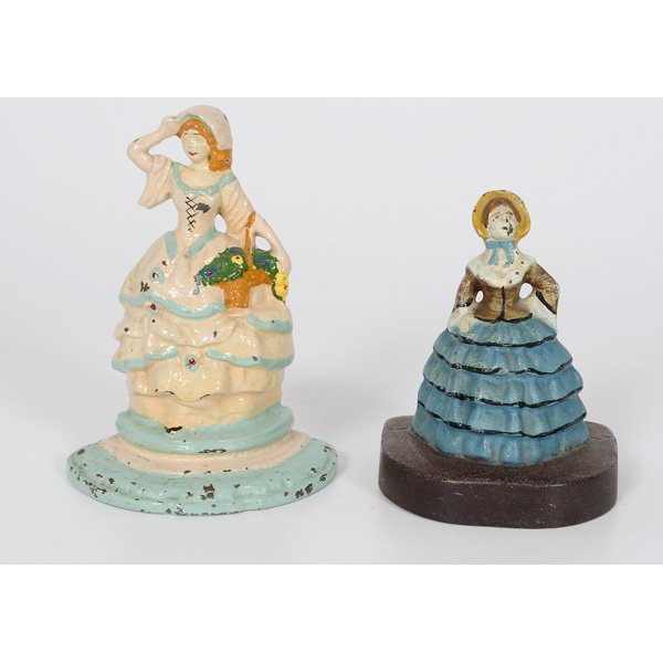 Victorian Women Cast Iron Doorstops : American, two painted cast iron Victorian women doorstops, unmarked; largest; ht. 7 in.