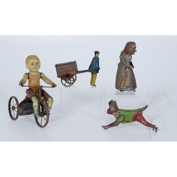 Tin Wind Up Toys : American, early 20th century, a group of tin wind up toys, including a girl on tricycle, a man with cart, a old woman walking, and a monkey; largest ht. 9 in.